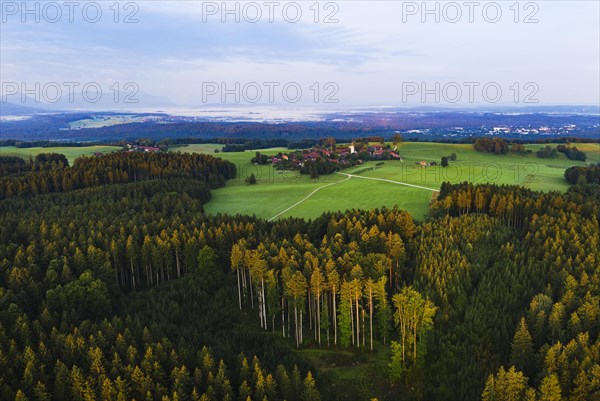 Forest with village Peretshofen near Dietramszell