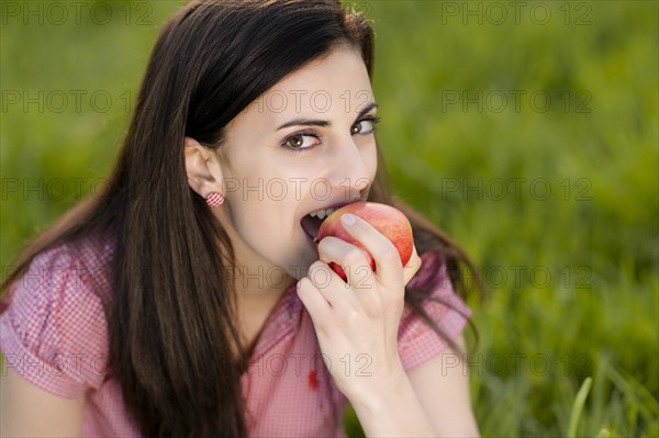 Woman eating an apple
