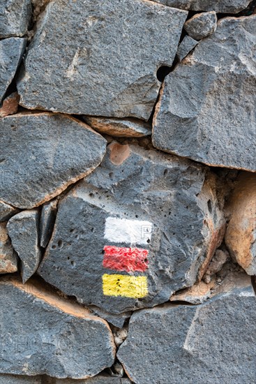 Marker for hikers on a rock