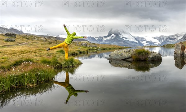 Hiker stretches his arms into the air