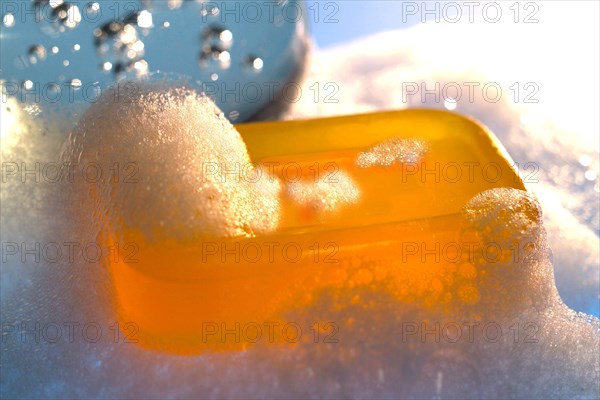 Bar of yellow glycerine soap with foam