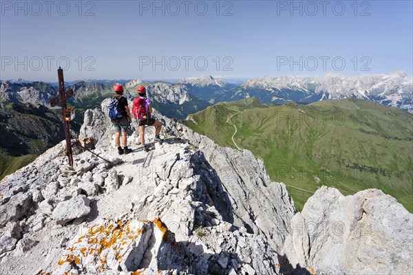 Climber on the summit of Colac on the Via Ferrata dei Finanzieri in Val di Fassa