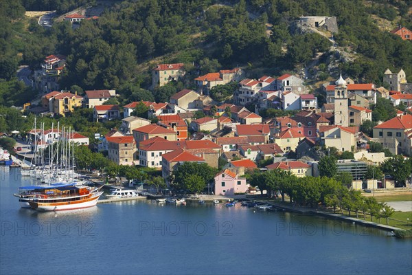 Townscape with sailing ship in the foreground