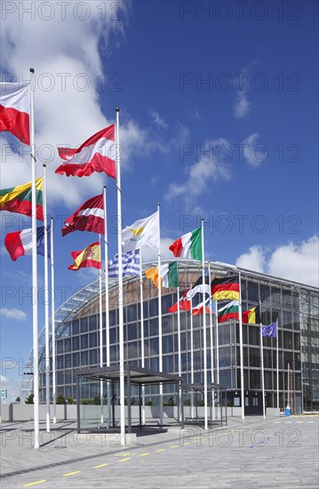 International flags waving in front of European Investment Bank