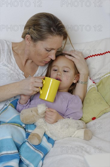 Mother taking care of her sick daughter