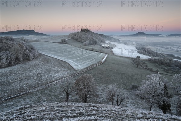 Hoar frost covered fields and meadows in Hegau with the Hohenstoffeln Mountain