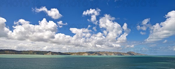 Coastal landscape with cumulus clouds