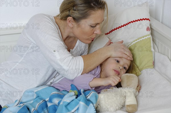 Mother taking care of her sick daughter