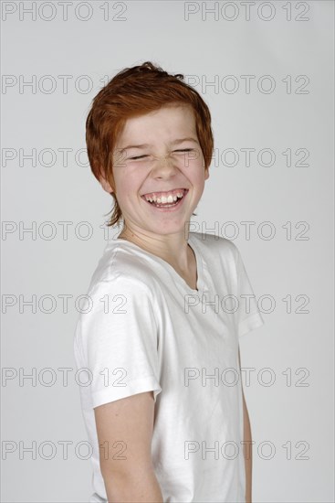 Boy laughing with his eyes closed