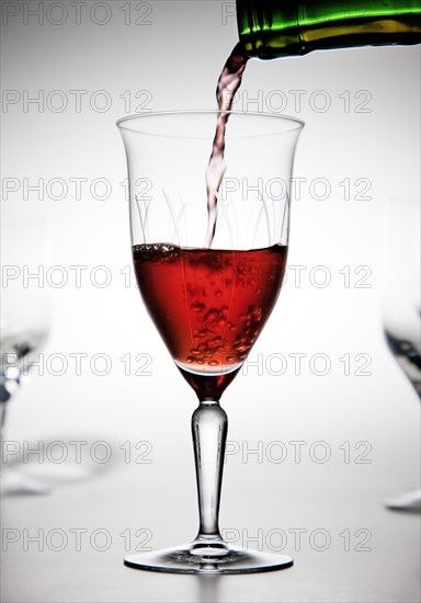 Red wine being poured into a wine glass