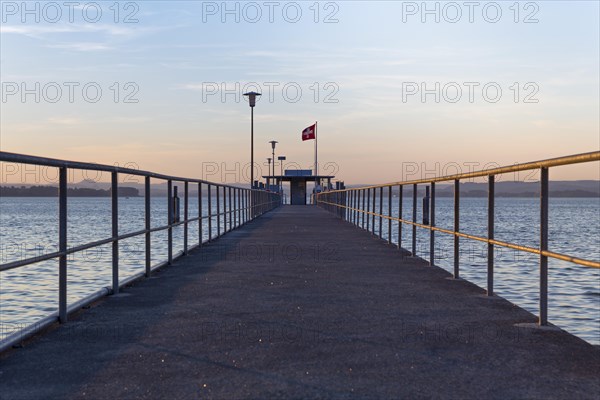 Railing of the ship pier of Mannenbach in the evening light