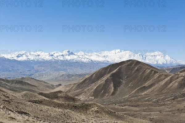 Vast landscape with the snow-covered mountains of the Annapurna Range at back