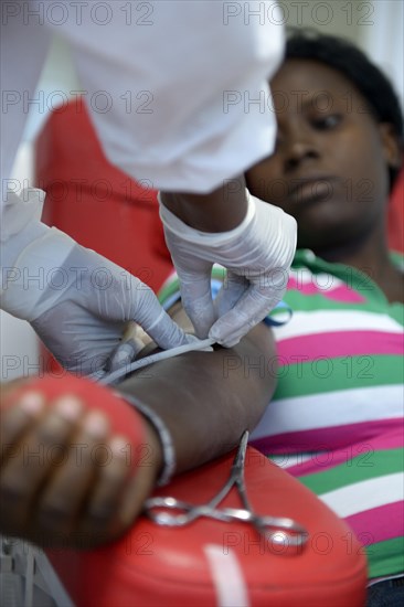 A woman is being prepared for a blood donation session