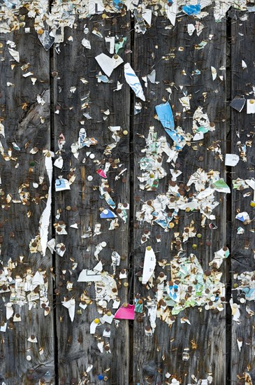 Wooden wall with poster scraps