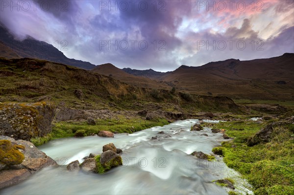 Mountain stream with the peaks of El Altar or Kapak Urku