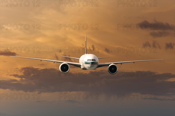 Cathay Pacific Boeing 777-367 ER in flight in the evening light