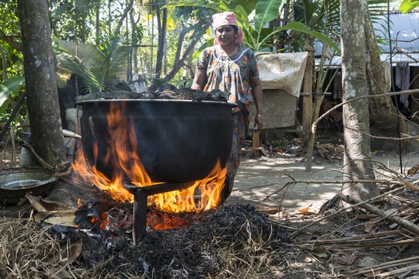 A woman cooking on open fire