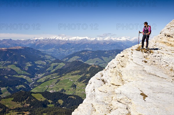 Mountain climber on Kreuzkofelscharte while ascending the Heiligkreuzkofelsteig climbing route on Heiligkreuzkofel Mountain in the Fanes Group