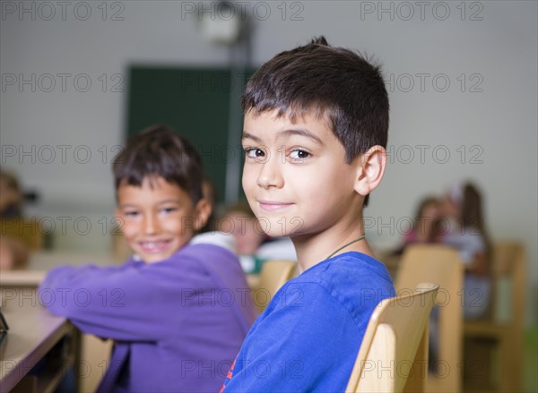 Elementary school children with an immigrant background sitting in a primary school class