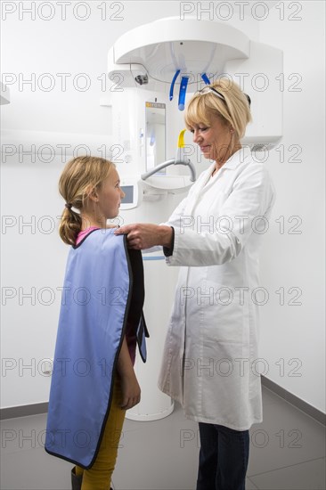 Girl being prepared for an x-ray of her teeth