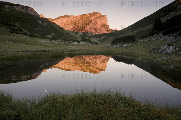 Rofanspitze peak at dawn reflected in Zireiner See