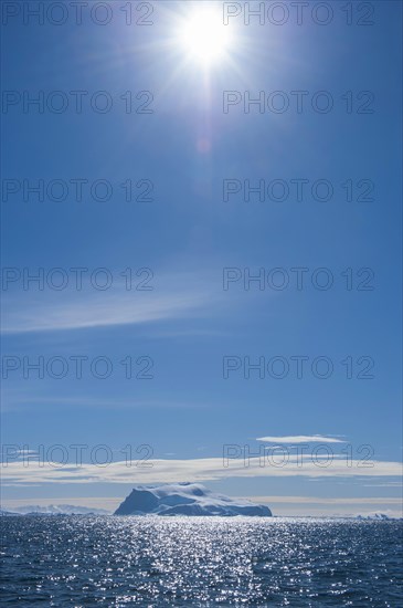 Sun shining over an iceberg
