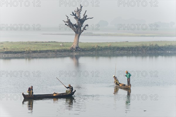 Fishermen in their boats in the morning light