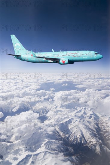 SunExpress Boeing 737 in flight over mountains