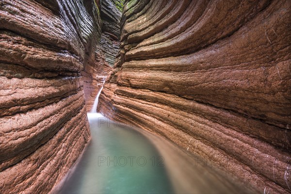 The Taugl river flowing through a red gorge