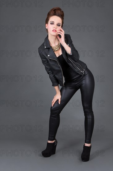 Young woman wearing a leather outfit