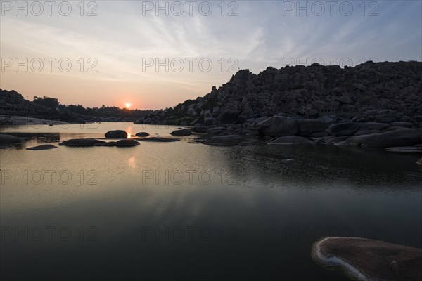 Sunset over Tungabhadra river and a part of the ruins of the former Vijayanagara Empire