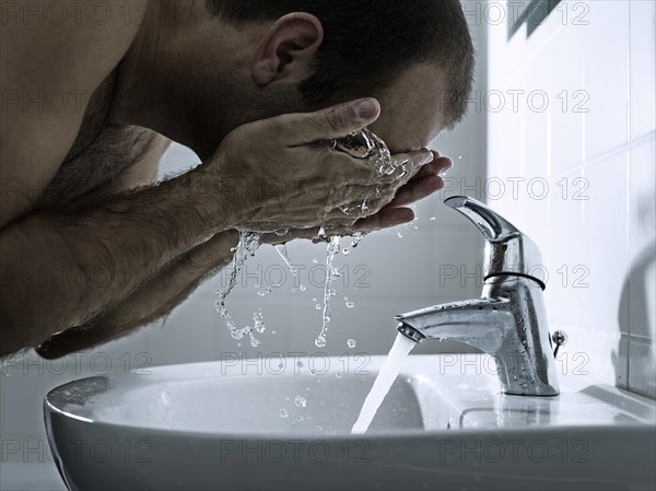Man washing his face with both hands