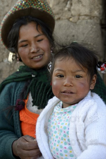 Young woman with girl in traditional costume