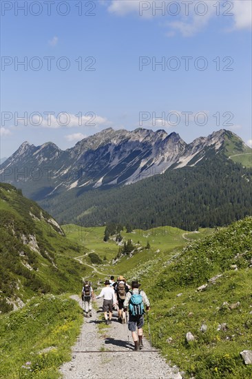 Hikers hiking above the Laguz Alps and Breithorn Mountain