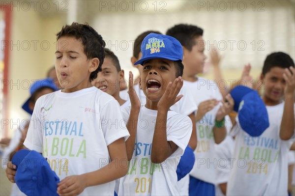 Children cheering on their team during a soccer tournament