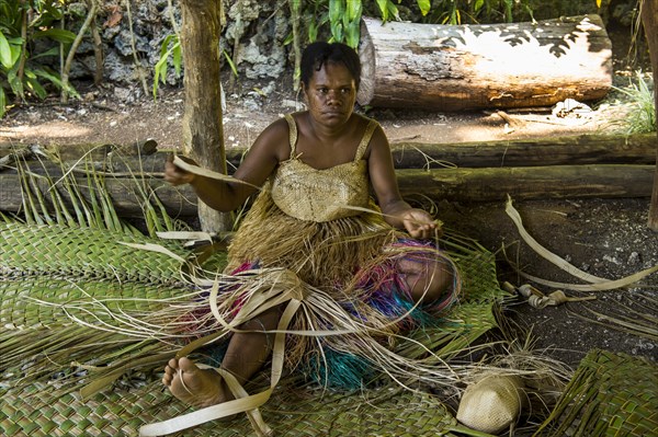 Woman weaving traditional baskets