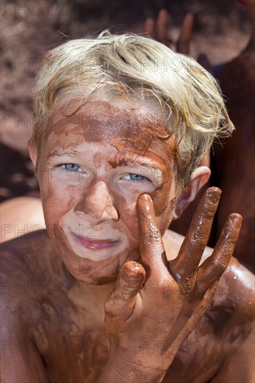 Boy applying healing earth