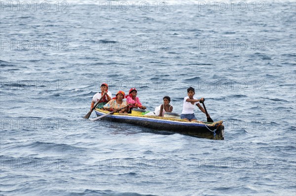 Kuna Indian women in a dugout canoe