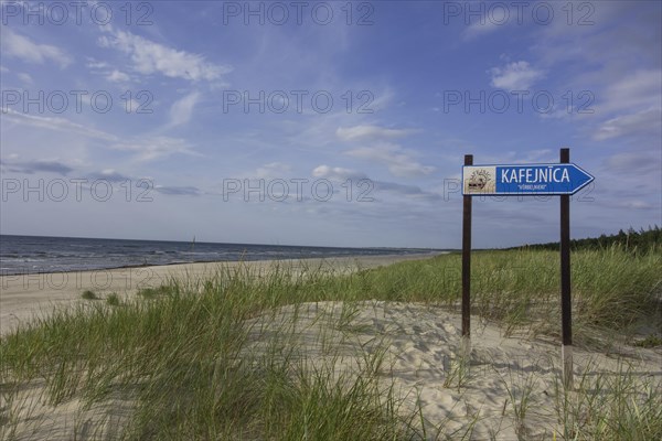Sandy beach on the Baltic Sea with sign for a cafe