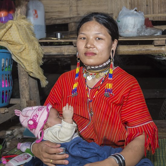 Long-necked woman with her baby