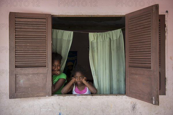 Children at the window of a house