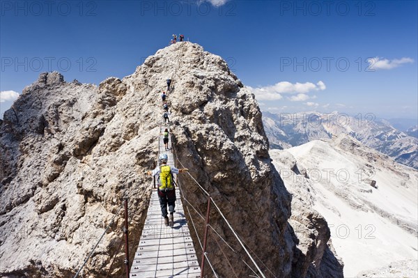 Mountain climbers ascending Cristallino Mountain on the Via Ferrata Ivano Dibona climbing route on Monte Cristallo