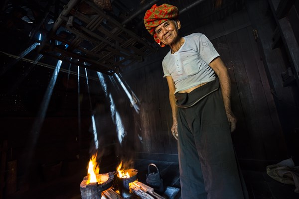 Elderly man at an open fire in the hut