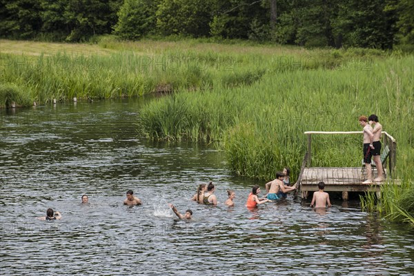 Young people bathing in the Krutynia River