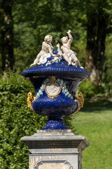 Ornamental vessel with putti made of glazed ceramic