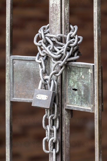 Chain with padlock on an iron gate