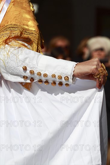 Woman in traditional costume taking part in a parade