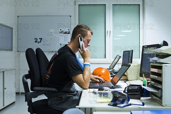 Electrician performing maintenance work on the substation premises of Transmission Control Center