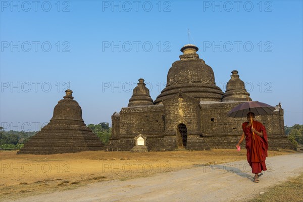 Buddhist monk with a parasol