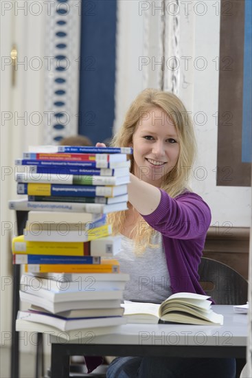 Student studying in the departmental library of the University of Hohenheim in Schloss Hohenheim Palace